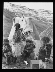 Image of Inuit family by tupik. Baby in hood
